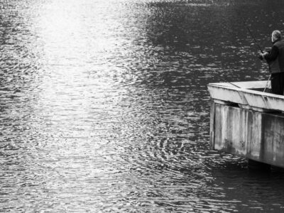 Fishing rod on a dock overlooking a calm lake