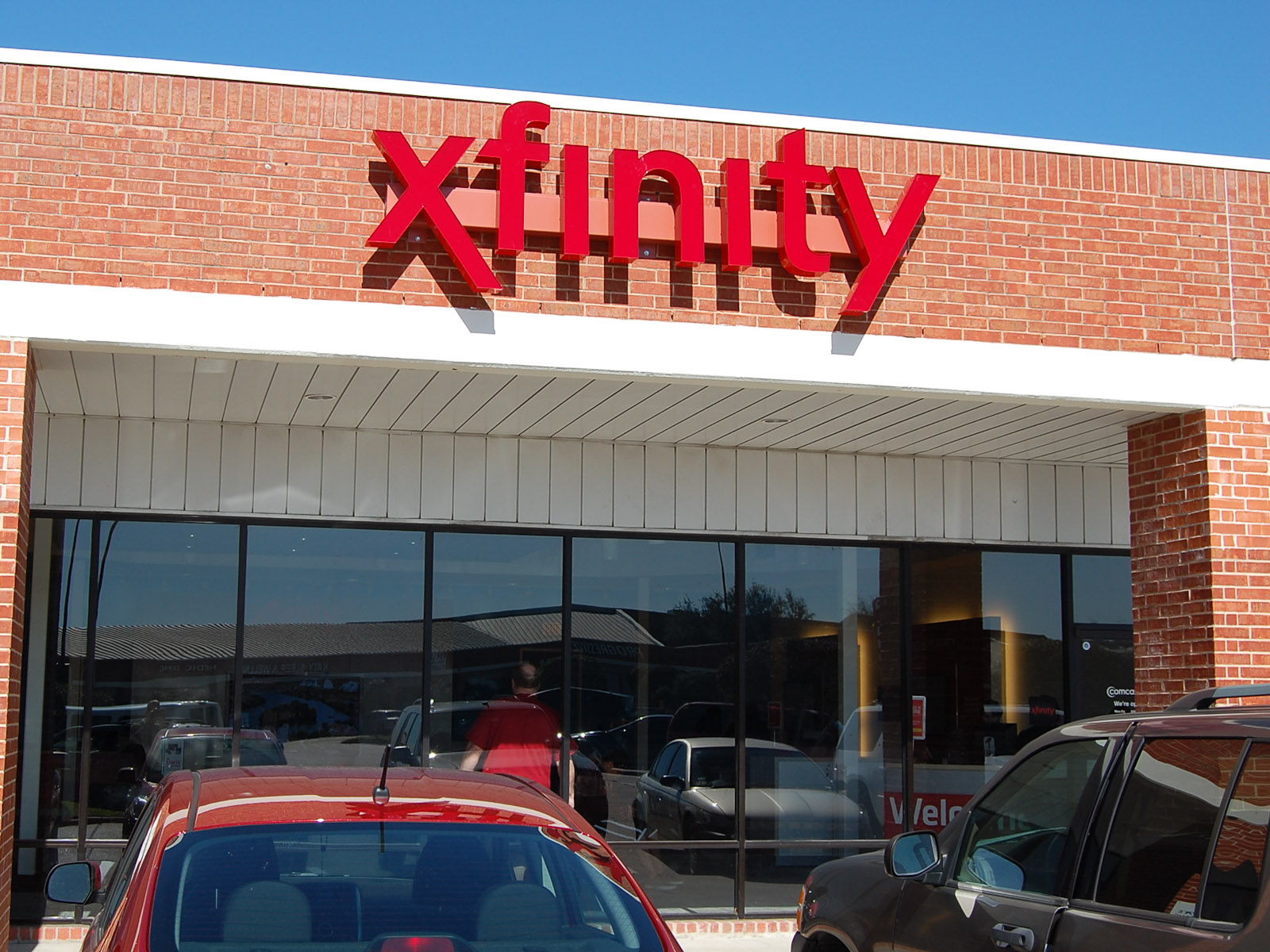Xfinity store display offering free Minions and Monsters merchandise