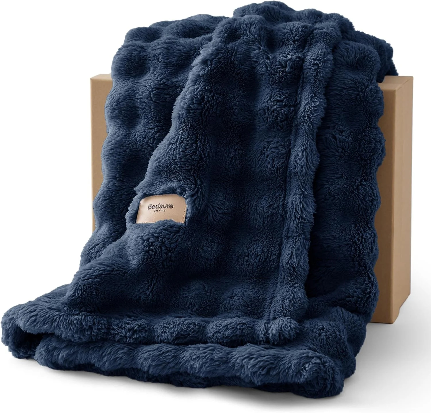 3D fleece bubble blanket displayed on a couch, sold on Amazon