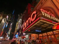 AMC Theatres marquee lit up at night, AMC movie ticket bundles on sale at Giftory